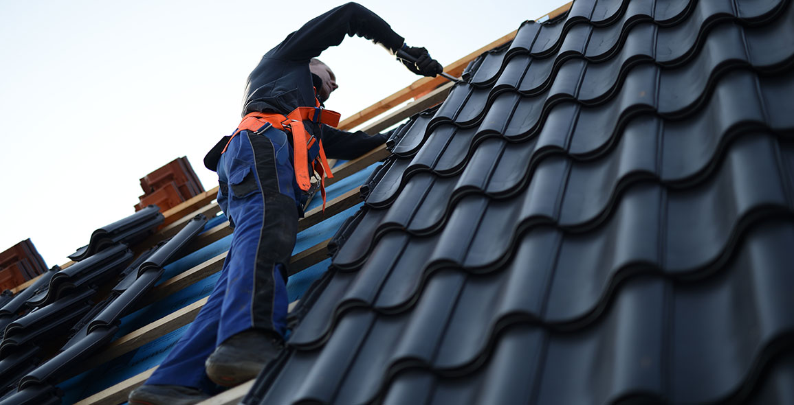 roofer working repairing a roof