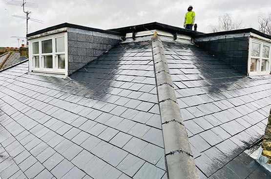 roofer on a roof with a hi vis jacket
