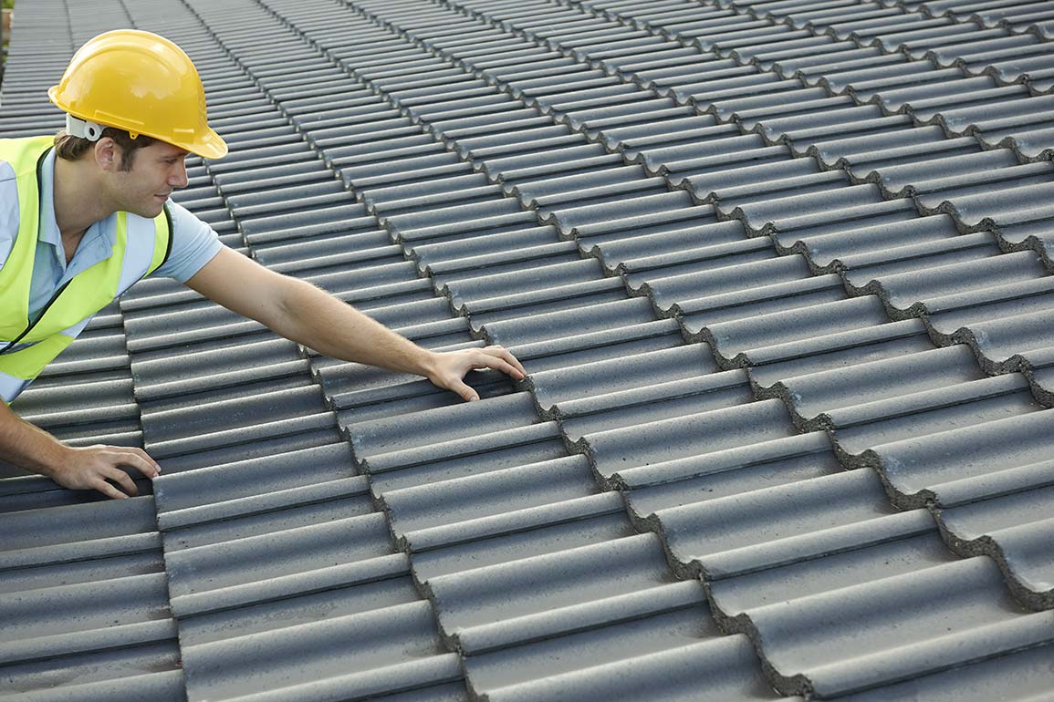roofer inspecting roof tiles