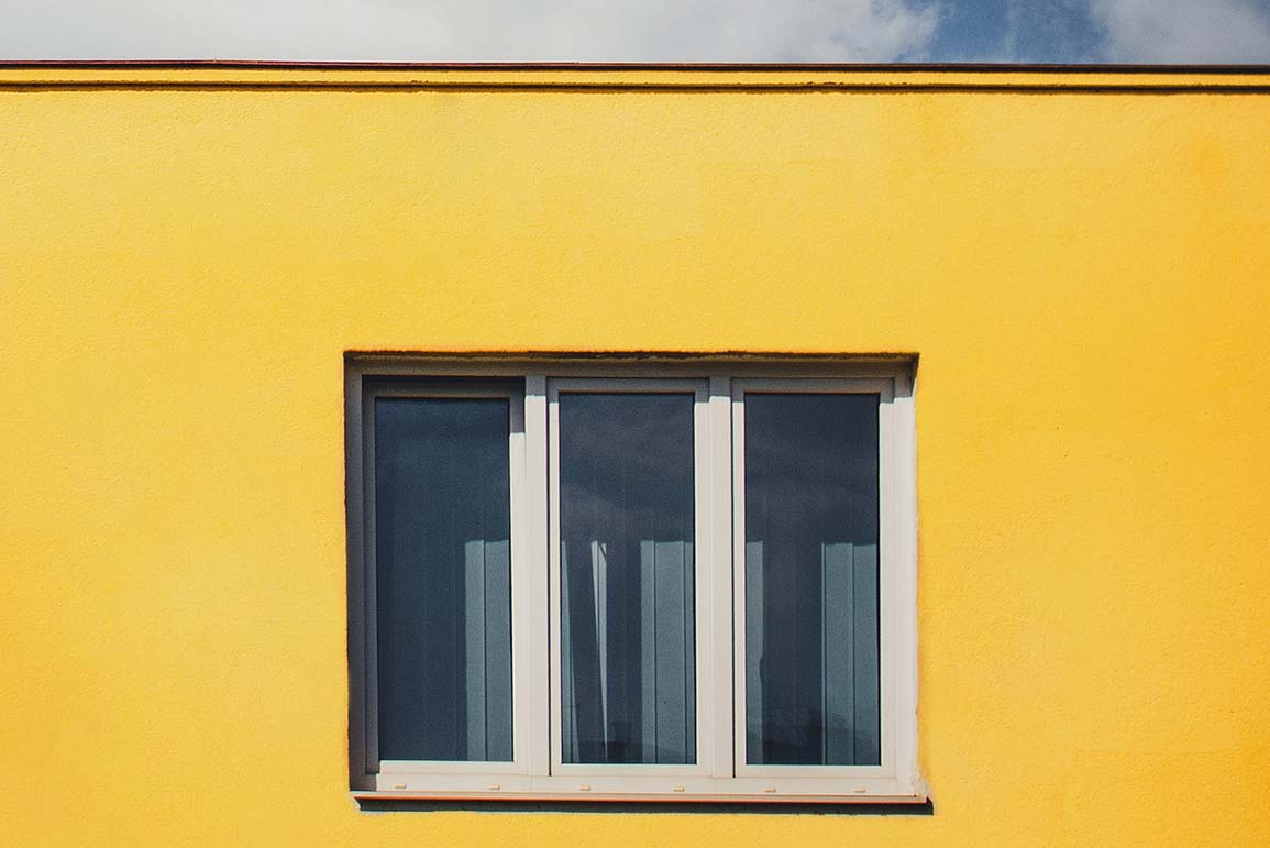 yellow painted wall with a window